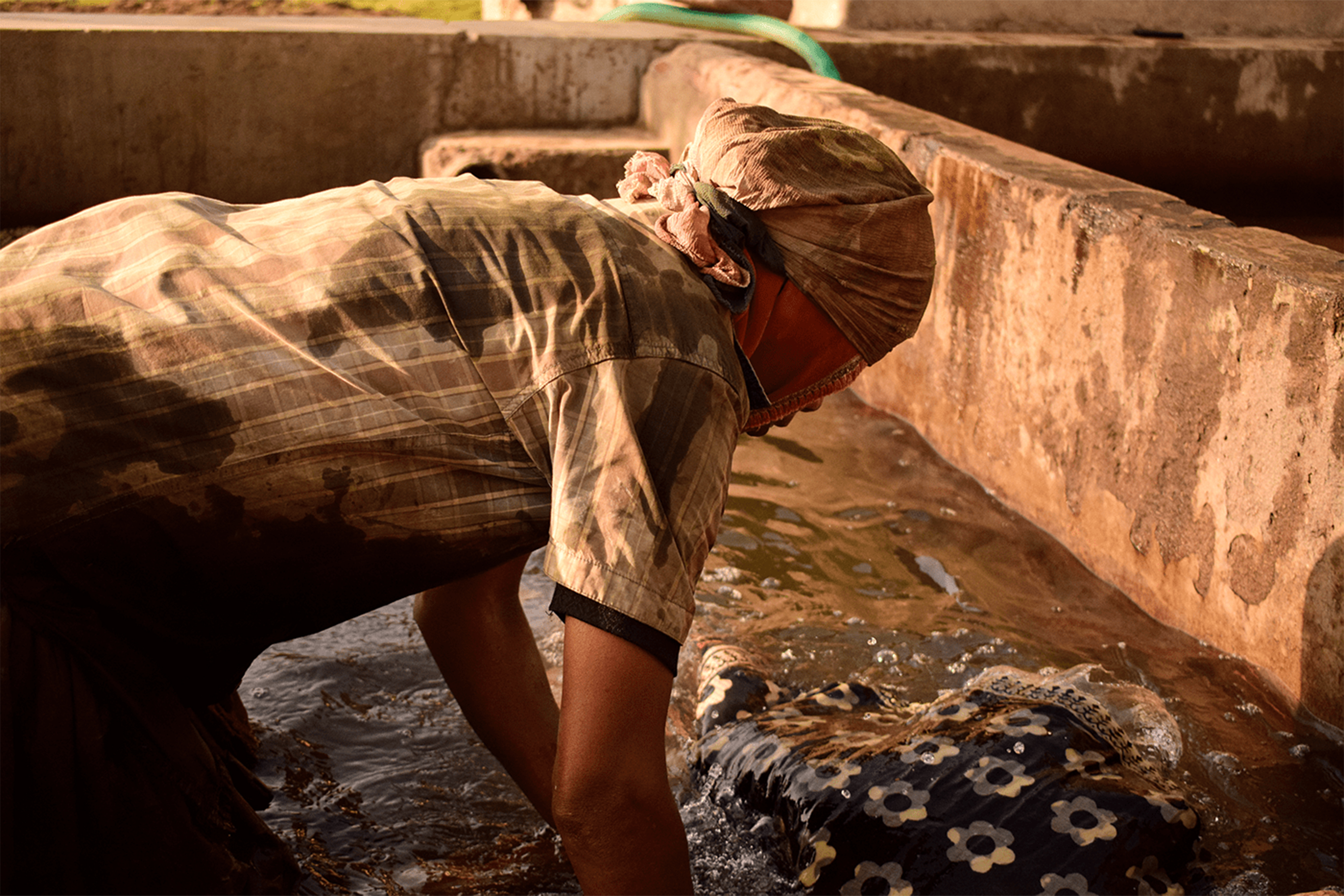 Hand-carved blocks press the mud resist onto the fabric.
